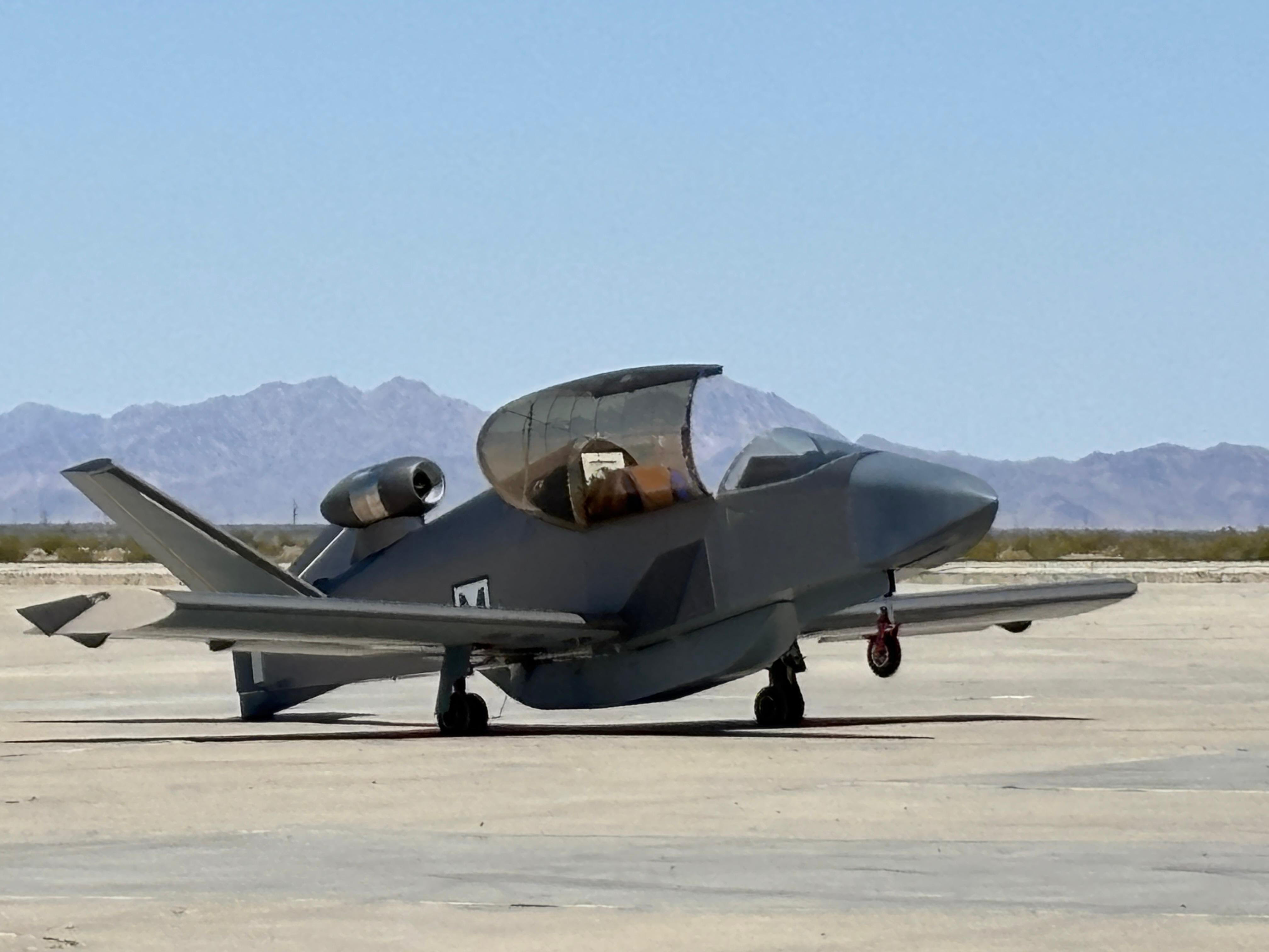 KX-1 aircraft on desert tarmac