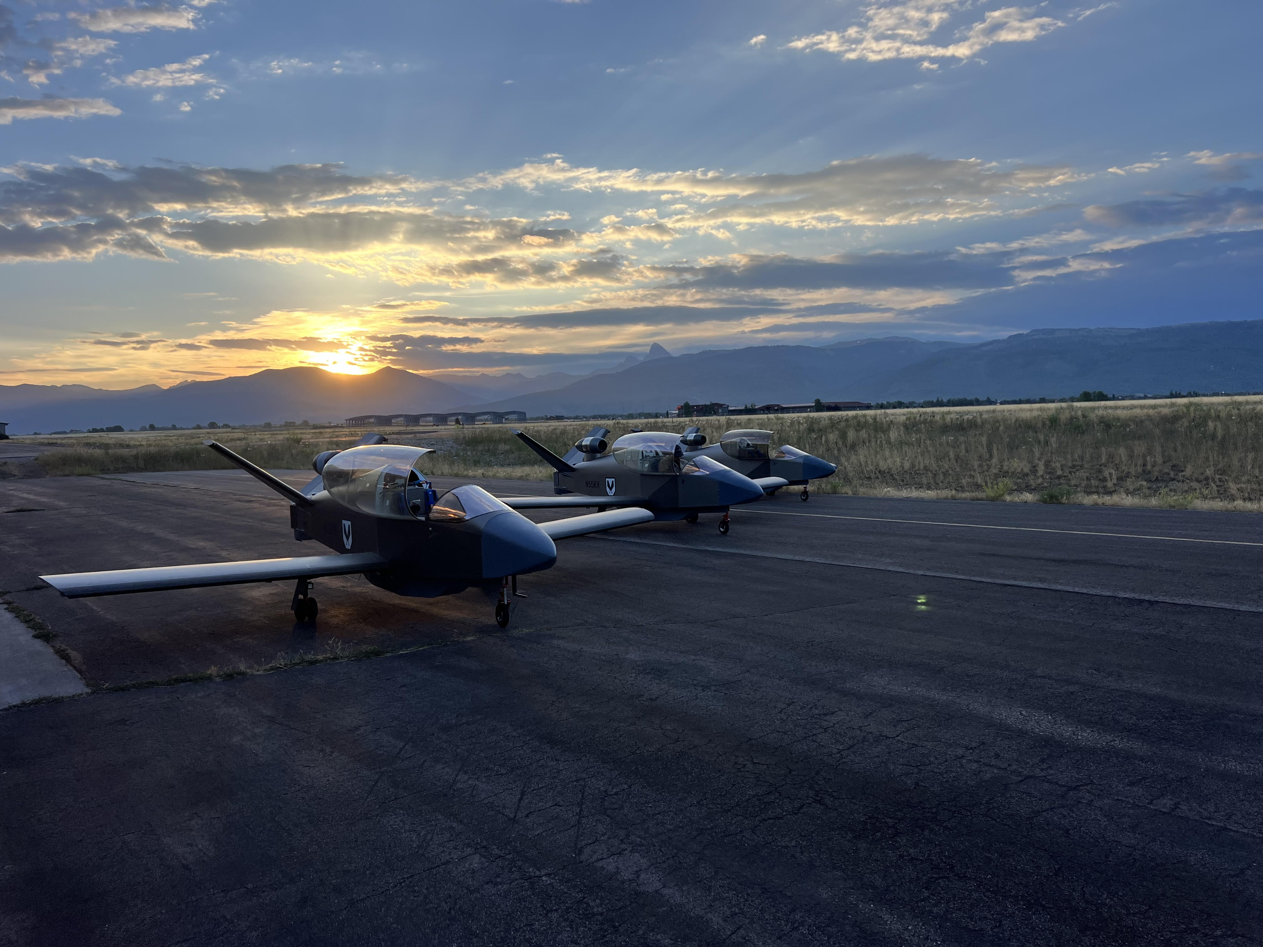 Three KestrelX aircraft on the ramp at sunset